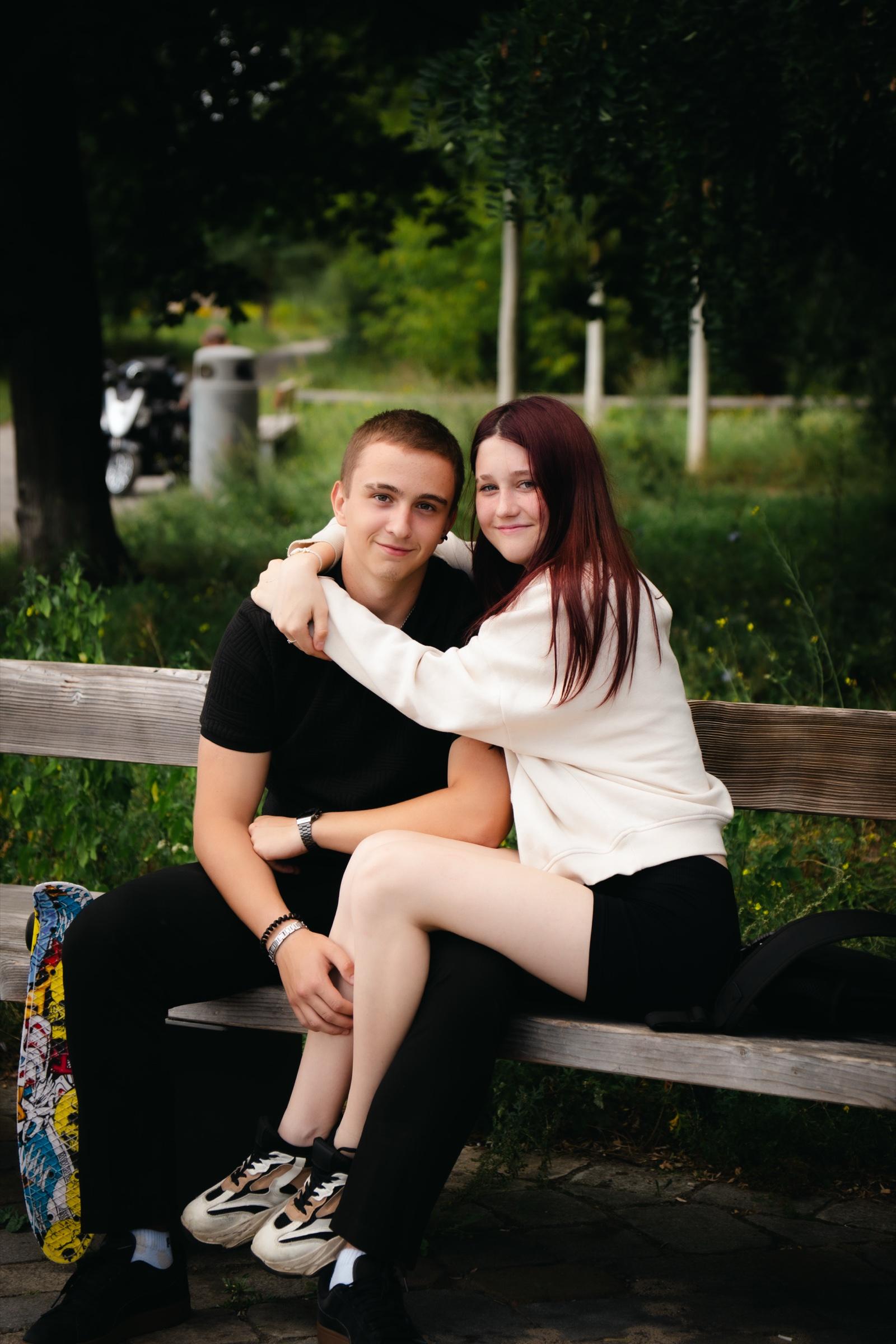Couple sitting on a wooden bench in a garden
