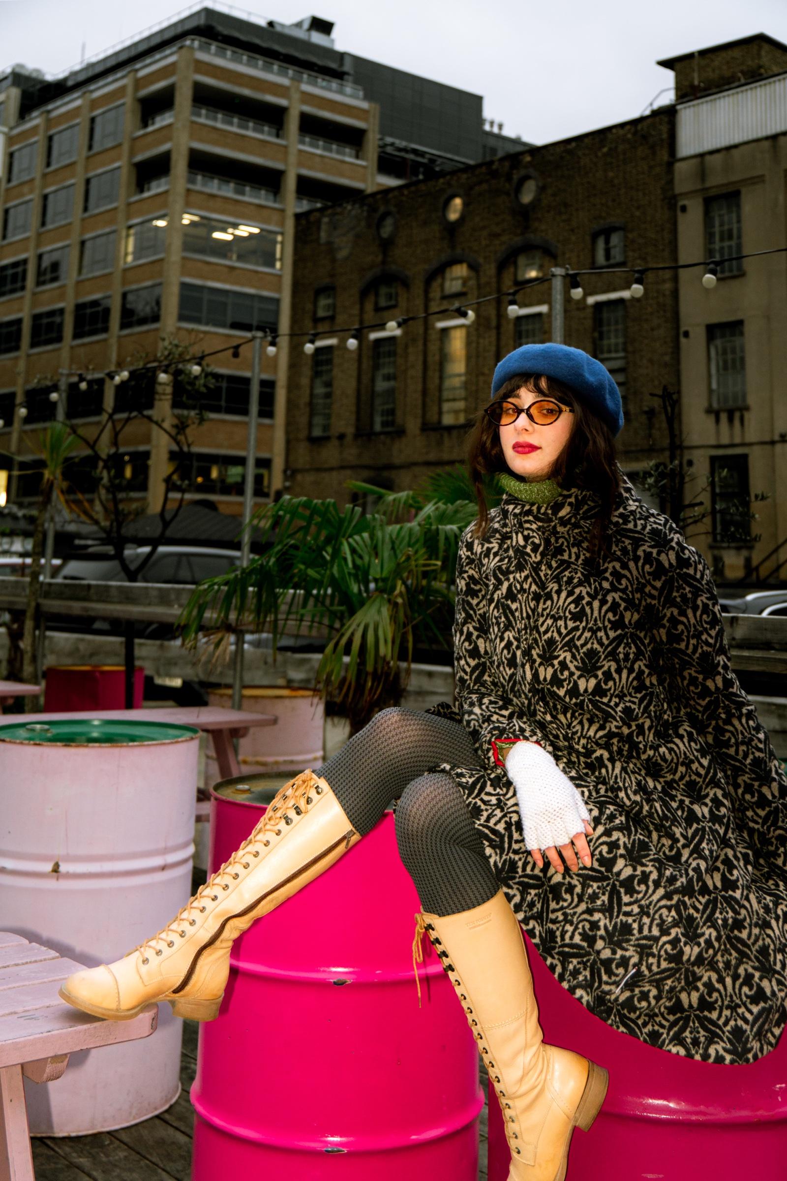 Editorial portrait on rooftop with pink barrels