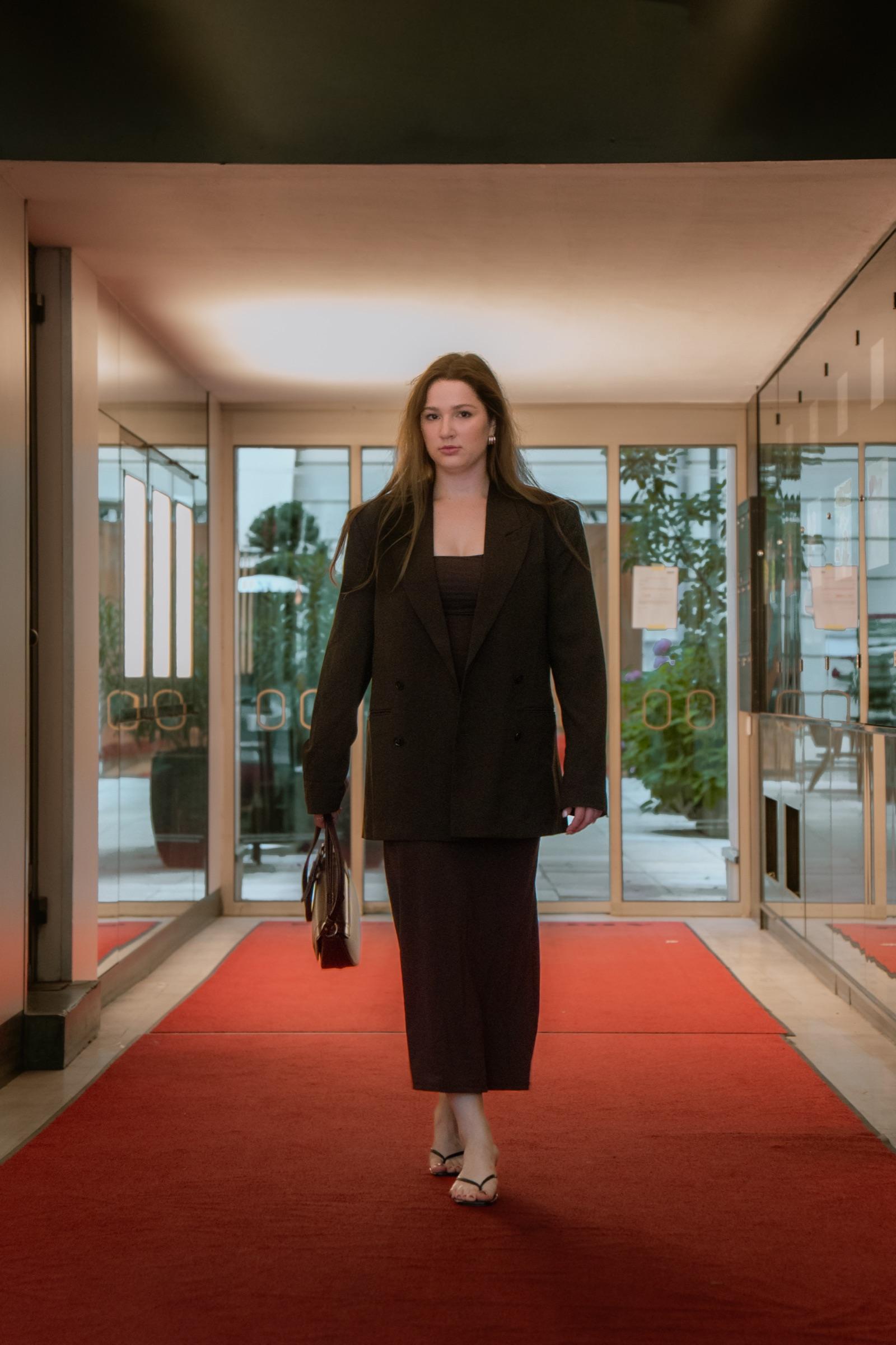 Editorial portrait walking a red carpet in an oversized blazer
