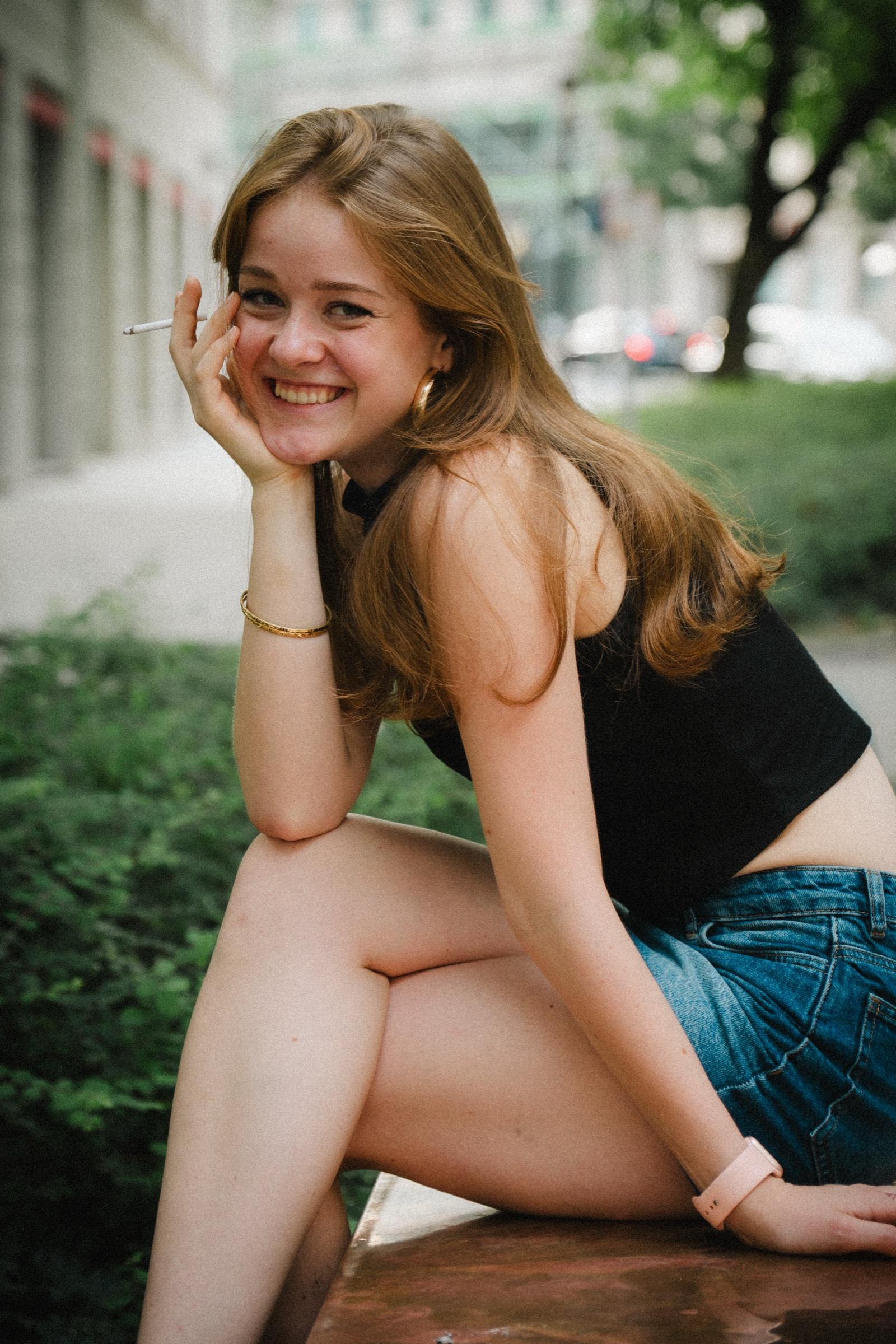 Candid portrait of a woman laughing on a bench