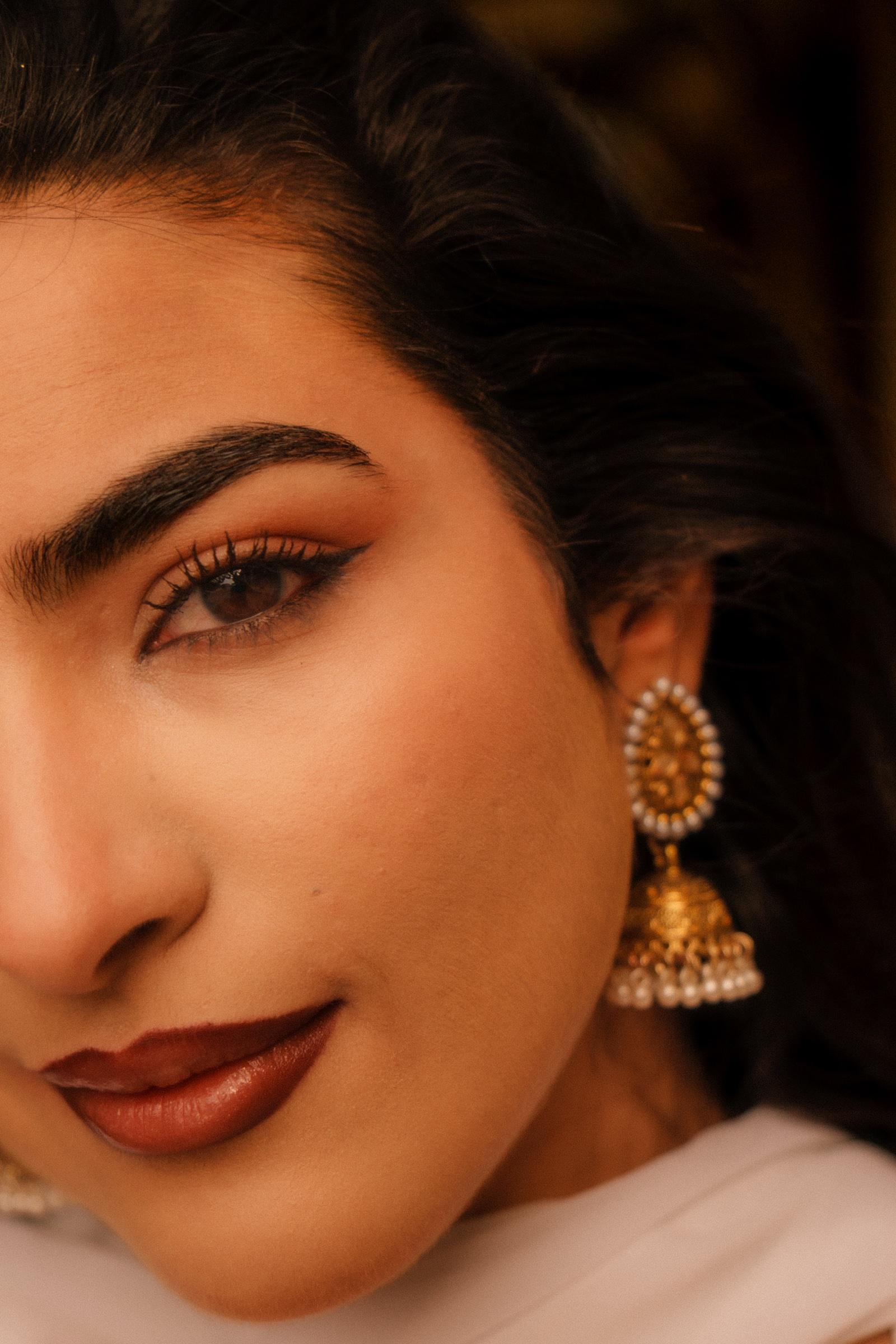 Close-up detail of a portrait with traditional earring