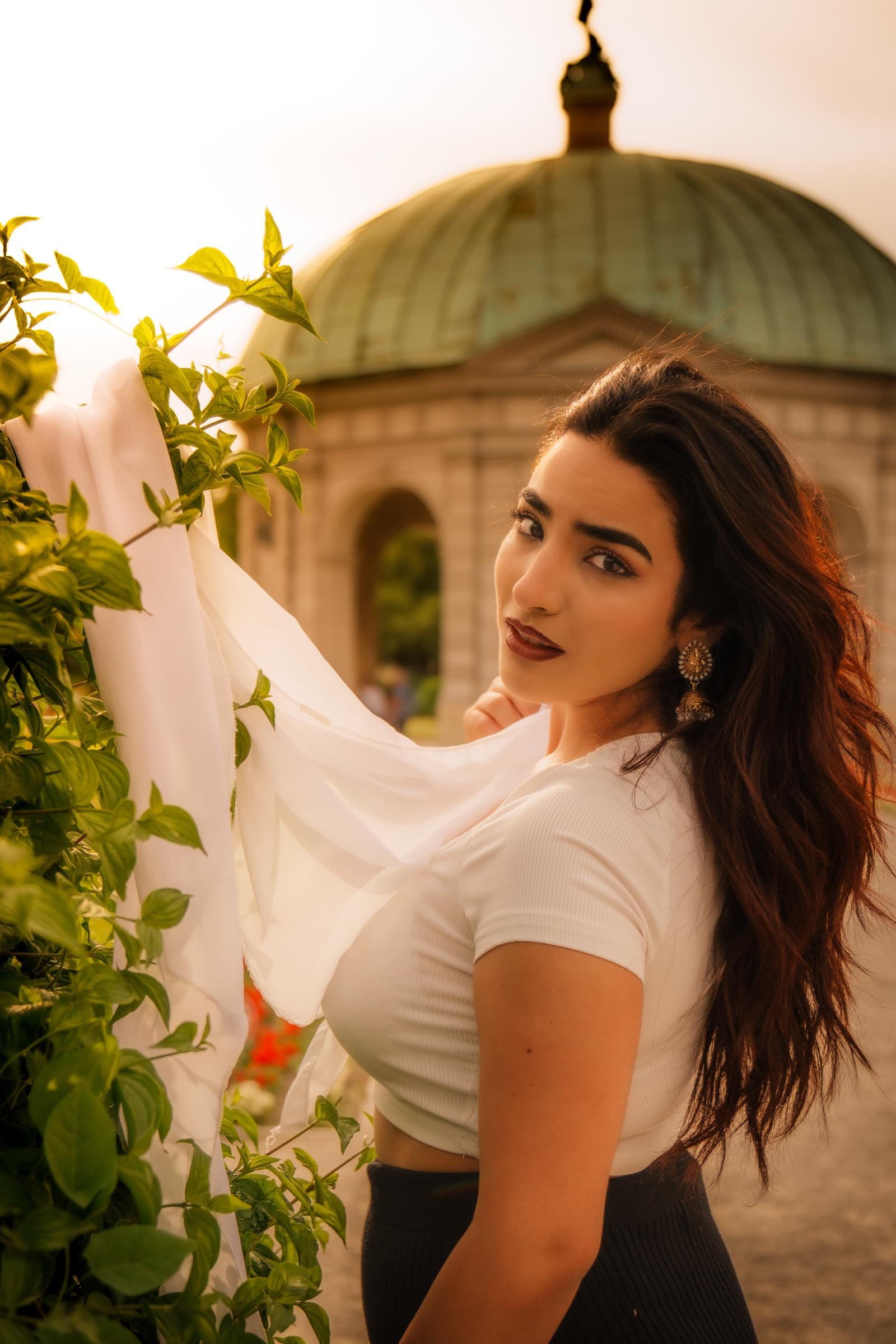 Editorial portrait by a garden pavilion with a green copper dome