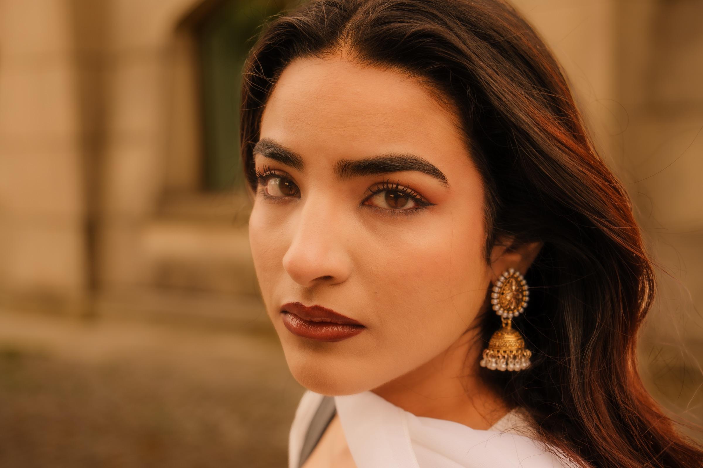 Golden-hour portrait of a woman gazing softly at the camera