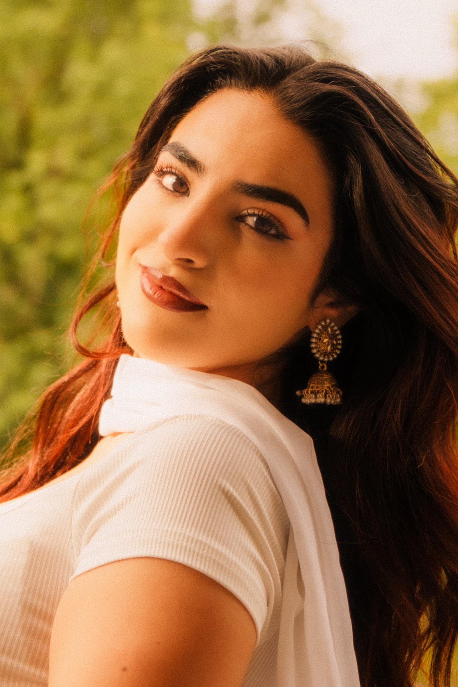 Portrait of a woman glancing over her shoulder in soft daylight